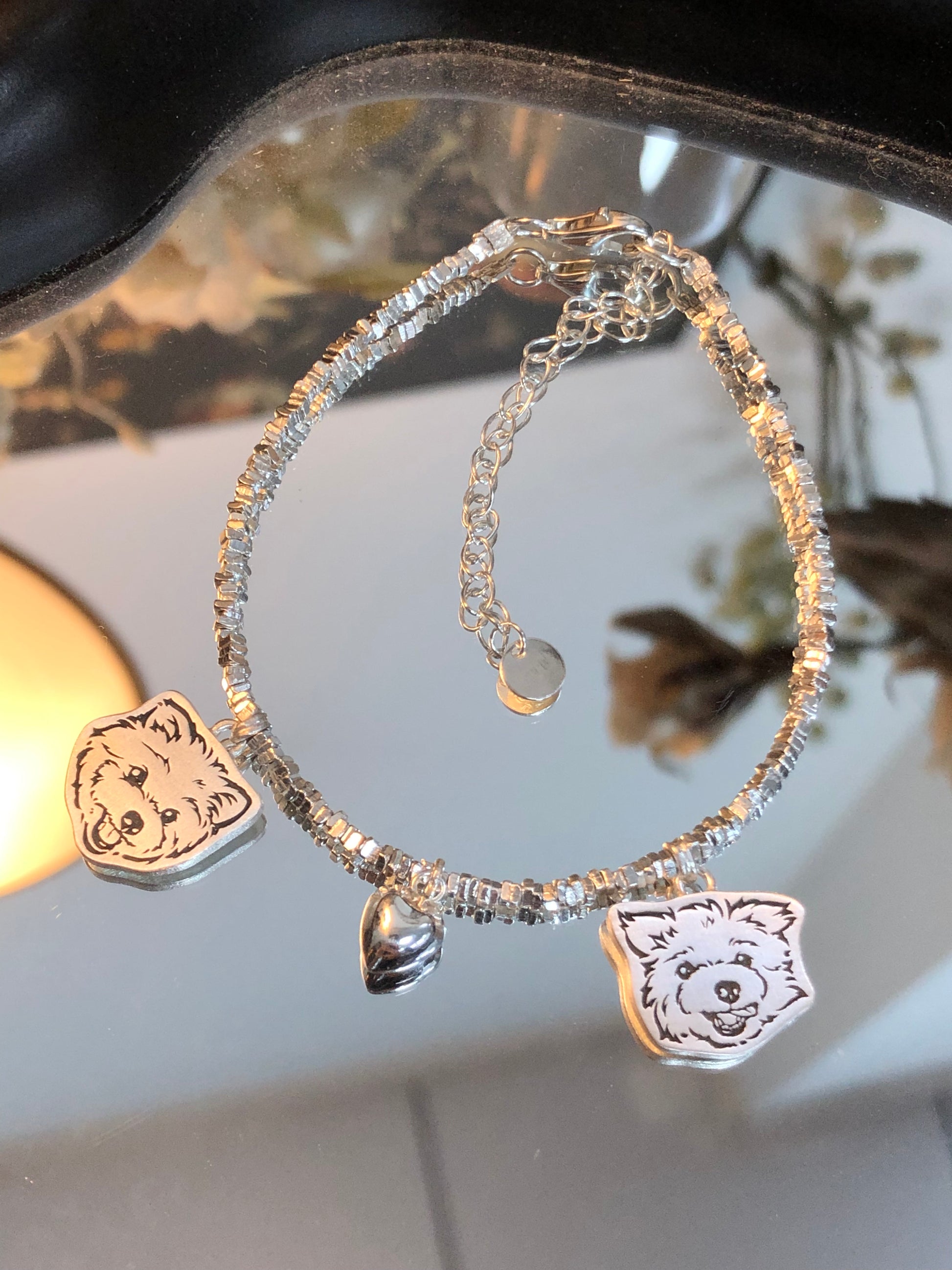 Close-up of the Two Dog Pendants and the Heart Pendant on our Crushed Silver Pet Face Bracelet