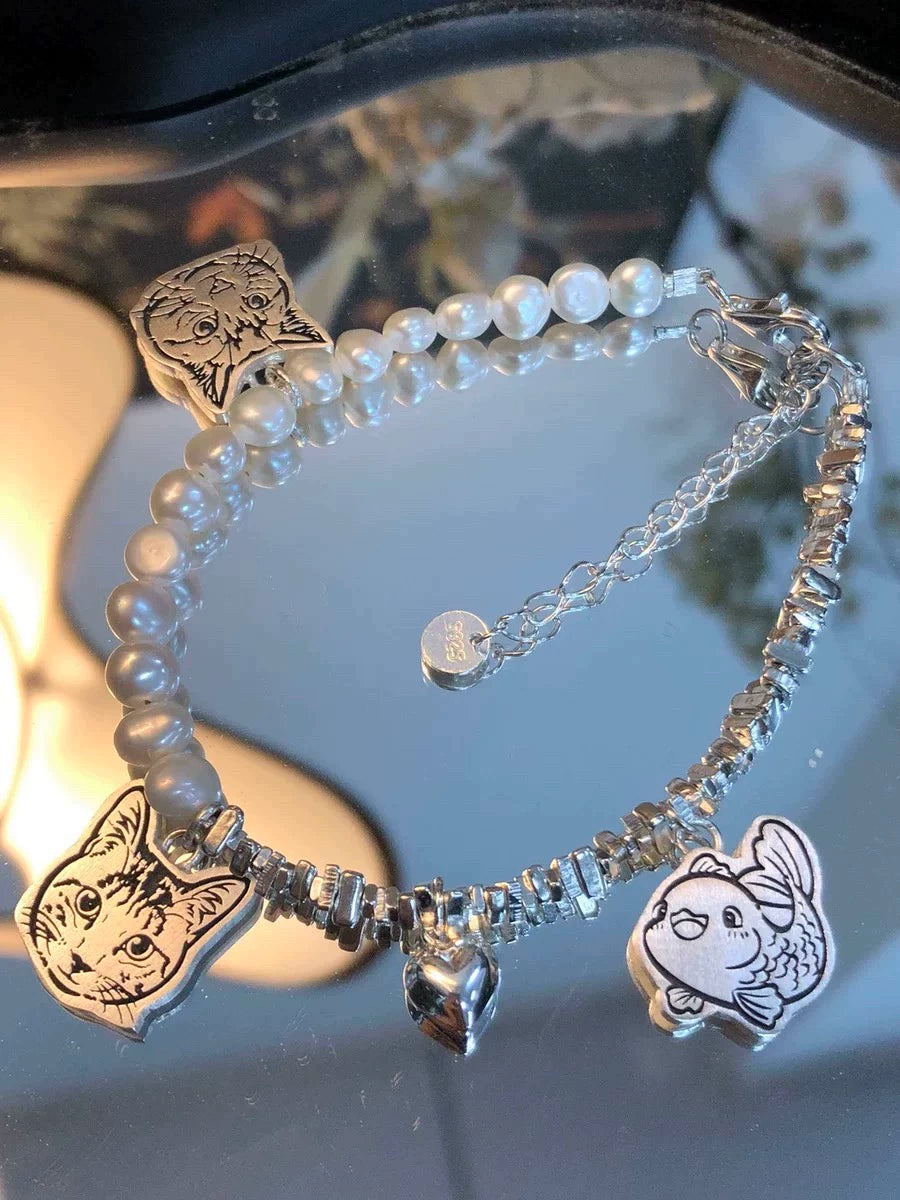 Close-up of the Three Pendants and the Heart Pendant on our  Pearl Pet Face Bracelet